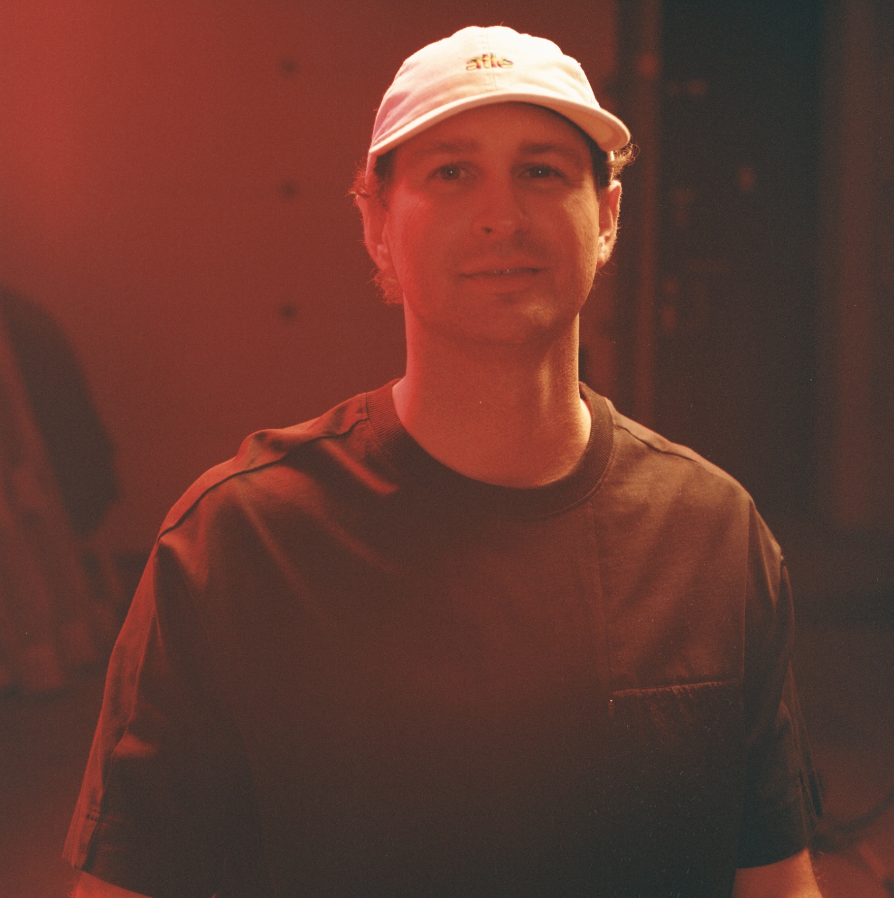 Portrait in red light, white cap